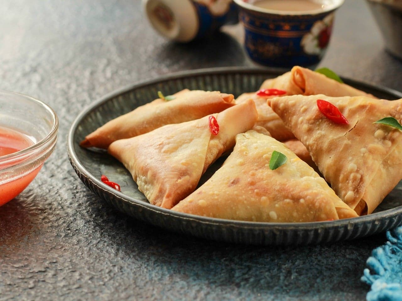 Samosas on a plate with chutney