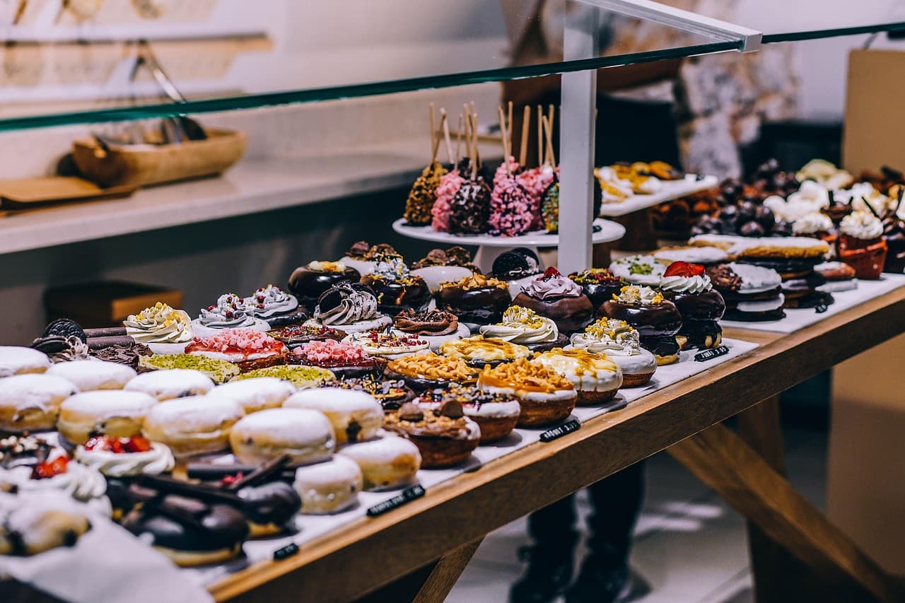 A cabinet of filled and topped donuts